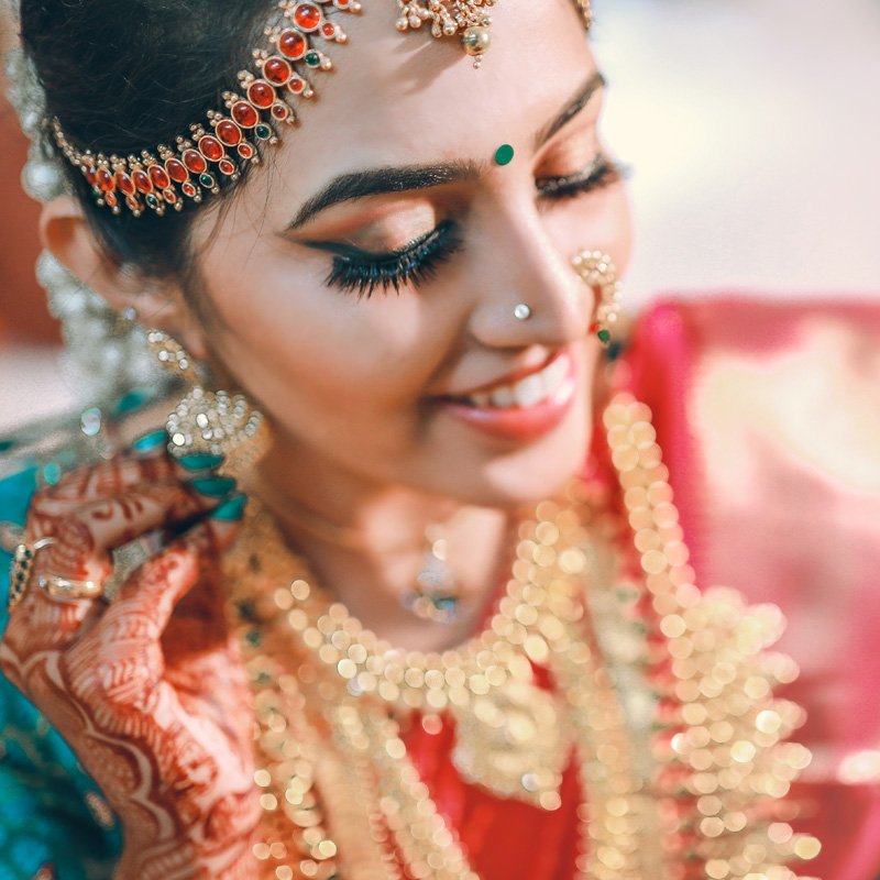Close-up of a smiling bride in traditional gold jewellery